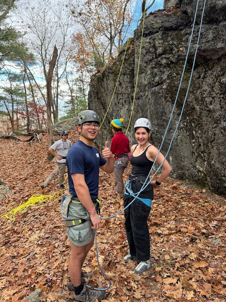 Two Northeastern University climbers getting ready to climb an outdoor route